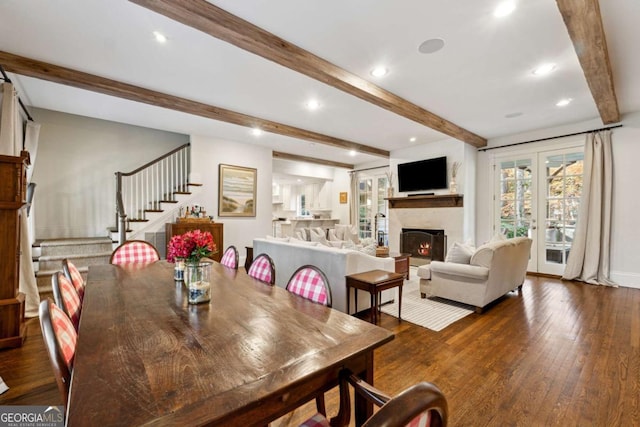 dining space featuring dark wood-type flooring, french doors, and beamed ceiling