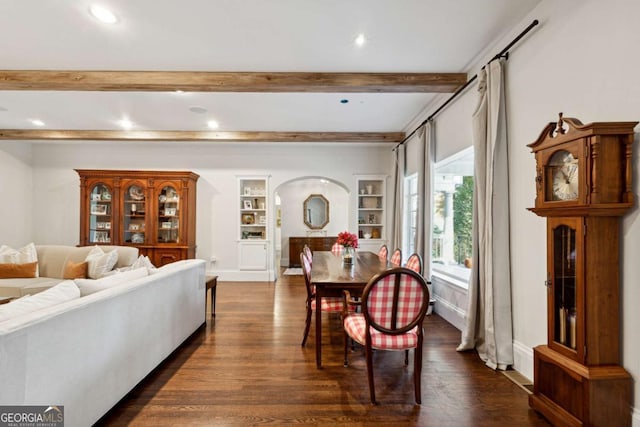 dining room featuring built in shelves, dark hardwood / wood-style flooring, and beamed ceiling