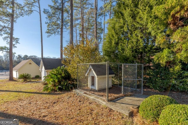 view of gate with an outbuilding