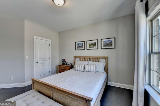 bedroom with dark hardwood / wood-style flooring