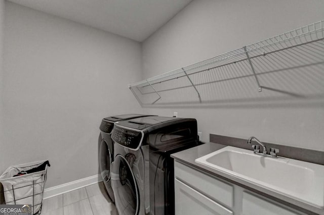 laundry area featuring separate washer and dryer and sink