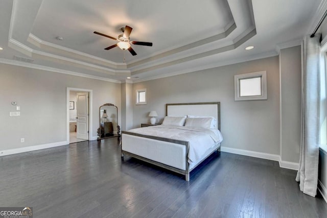 bedroom with ceiling fan, a tray ceiling, and crown molding