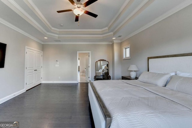 unfurnished bedroom featuring crown molding, dark hardwood / wood-style flooring, ceiling fan, and a raised ceiling