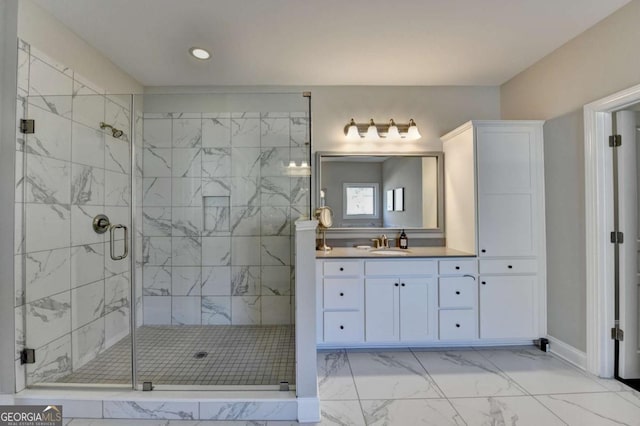 bathroom with a shower with shower door and vanity