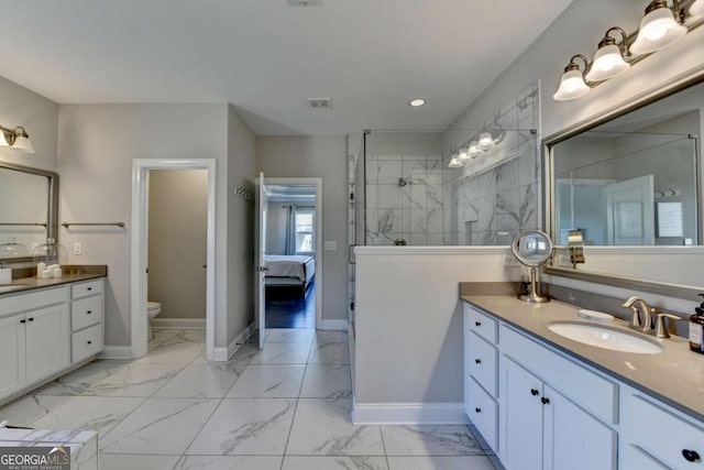 bathroom with tiled shower, toilet, and vanity