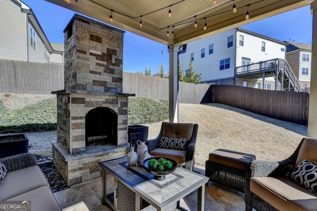 view of patio / terrace featuring an outdoor stone fireplace