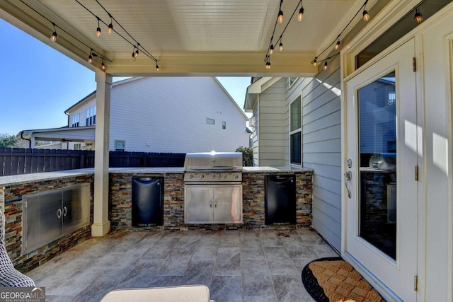 view of patio / terrace with exterior kitchen and a grill