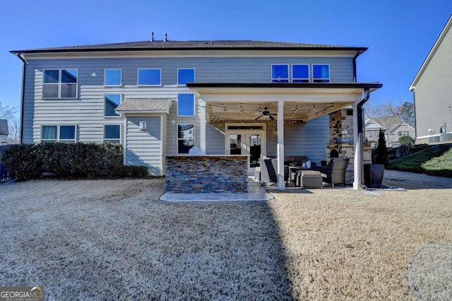 view of front of home with ceiling fan, a patio, and exterior bar