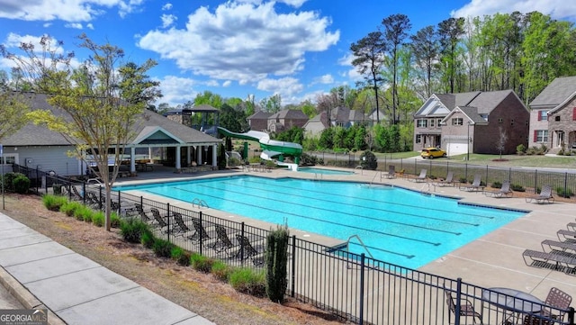 view of swimming pool featuring a patio and a water slide