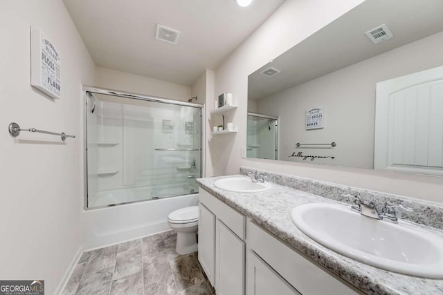 full bathroom with shower / bath combination with glass door, vanity, and toilet