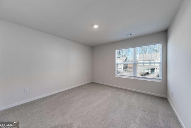 unfurnished room with light carpet