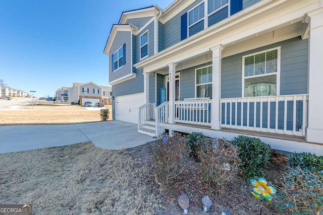 exterior space with a garage and covered porch