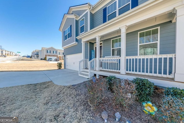 463 Walnut Grove Way, Pendergrass, GA 30567 - view of home's exterior featuring covered porch, an attached garage, and concrete driveway