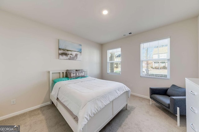 bedroom featuring light colored carpet