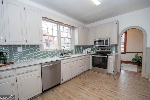 kitchen with sink, white cabinetry, and appliances with stainless steel finishes