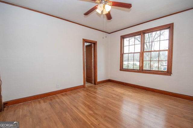 unfurnished room featuring crown molding, light wood-type flooring, and ceiling fan