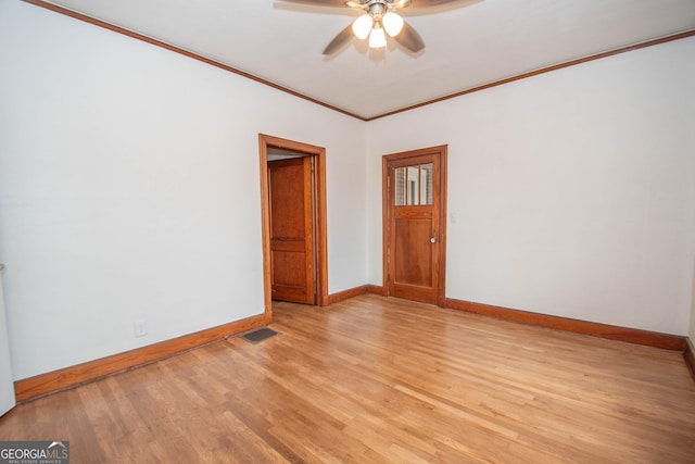 empty room featuring light hardwood / wood-style flooring, ceiling fan, and ornamental molding