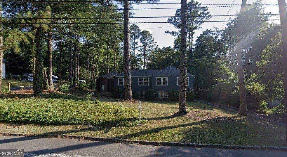 ranch-style home with a front lawn