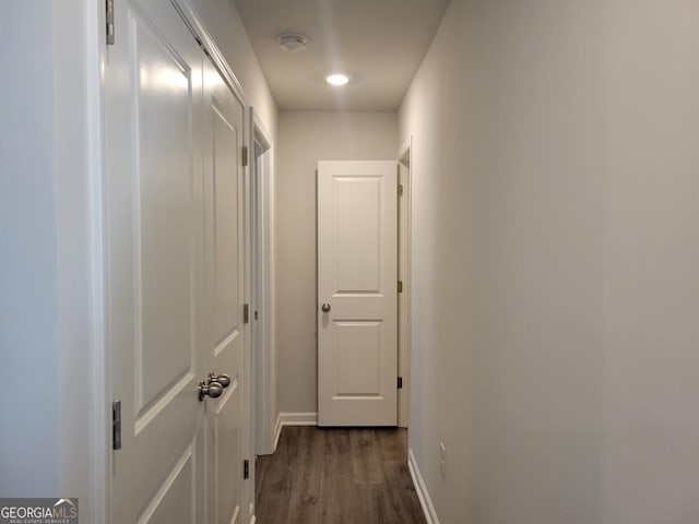 hallway with dark hardwood / wood-style floors