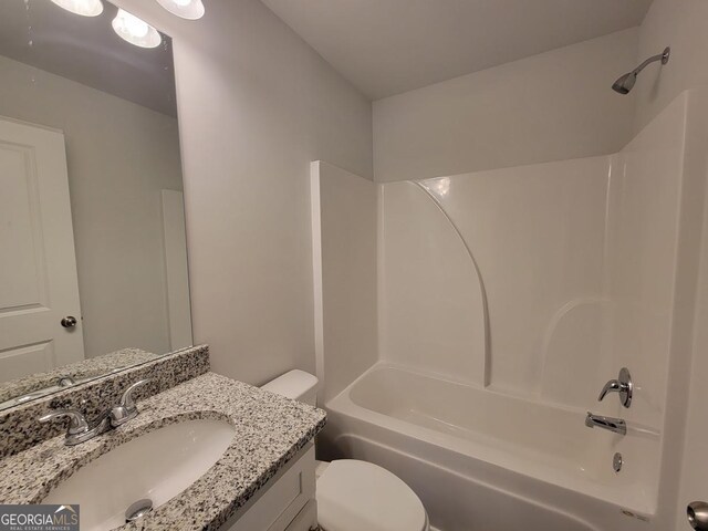 full bathroom with bathing tub / shower combination, toilet, and vanity