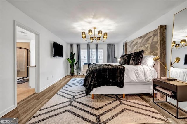 bedroom featuring wood-type flooring and an inviting chandelier