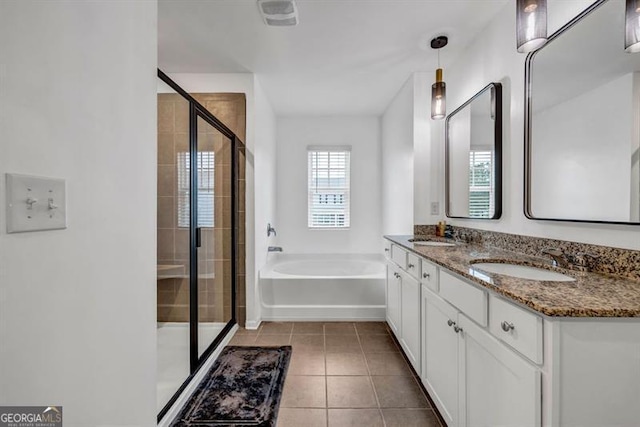 bathroom with tile patterned floors, vanity, and shower with separate bathtub