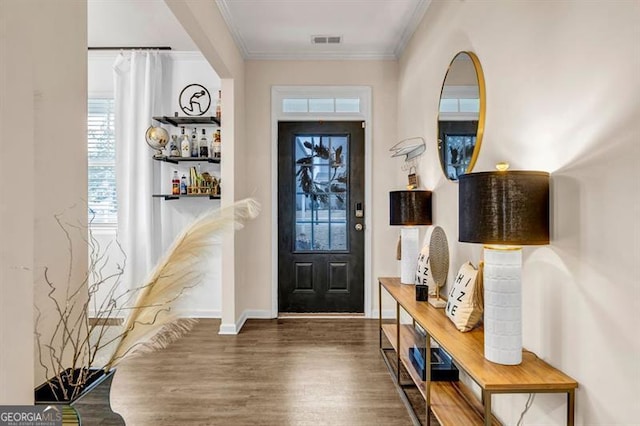 foyer featuring crown molding and dark hardwood / wood-style floors