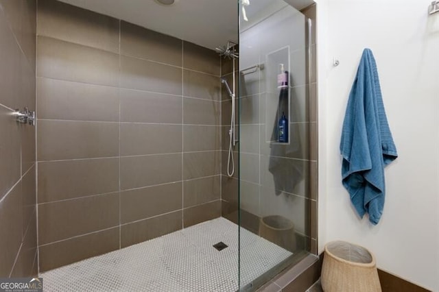 bathroom with a tile shower