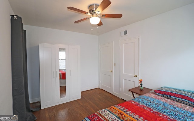 bedroom featuring dark hardwood / wood-style floors and ceiling fan