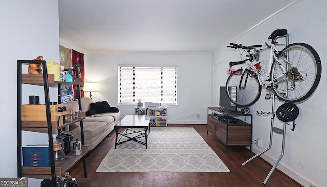 living room with dark wood-type flooring and ornamental molding