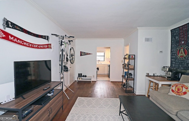 living room featuring dark hardwood / wood-style flooring and ornamental molding