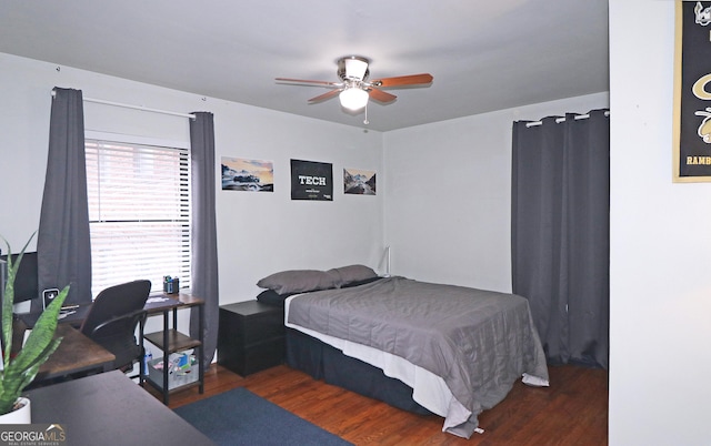 bedroom with ceiling fan, multiple windows, and dark hardwood / wood-style floors