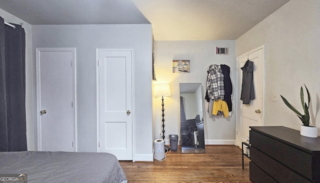 bedroom featuring dark hardwood / wood-style flooring