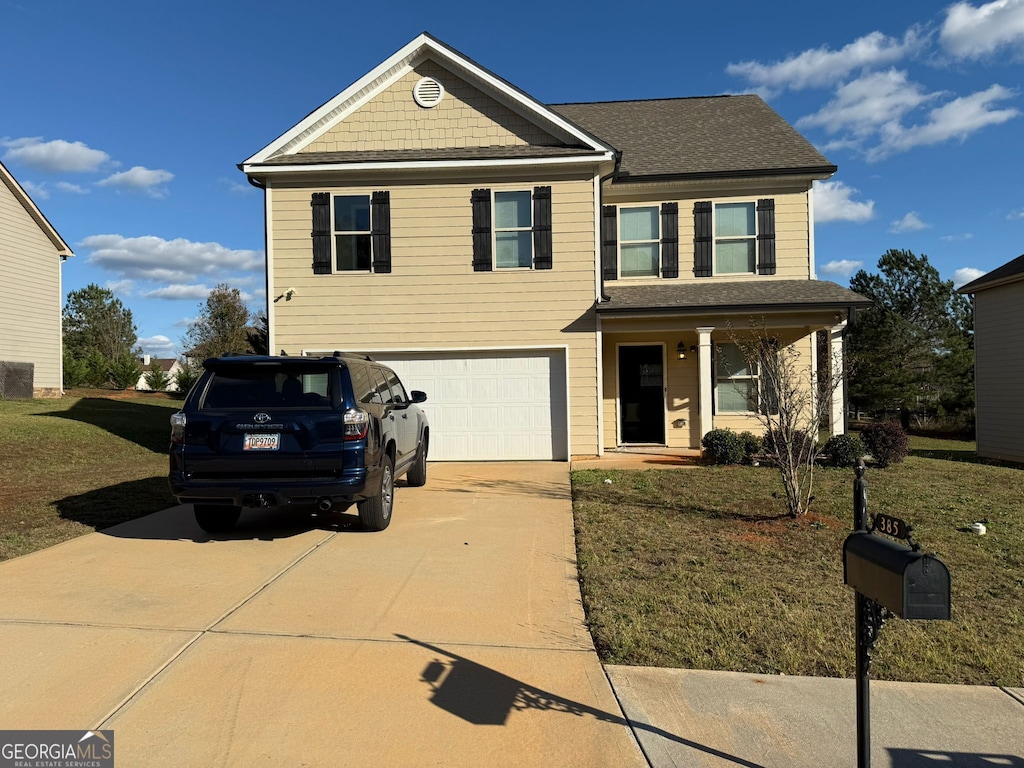 view of front of home with a garage and a front yard