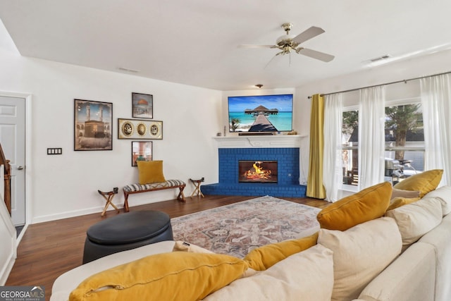 living room featuring a fireplace, ceiling fan, and dark hardwood / wood-style flooring