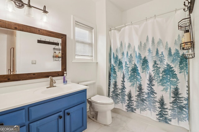 bathroom featuring toilet and vanity