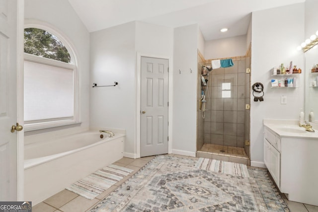 bathroom featuring vanity, independent shower and bath, and tile patterned flooring