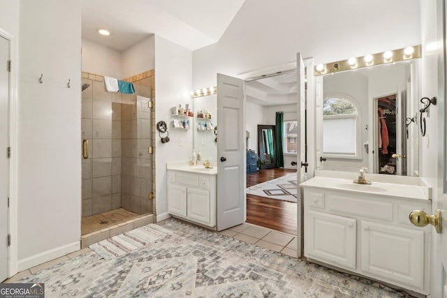 bathroom with tile patterned floors, vanity, and an enclosed shower