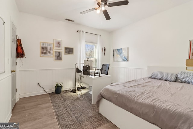 bedroom with ceiling fan and hardwood / wood-style floors