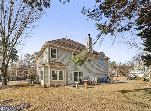 rear view of property with a patio area and a lawn