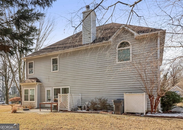 back of property with a patio