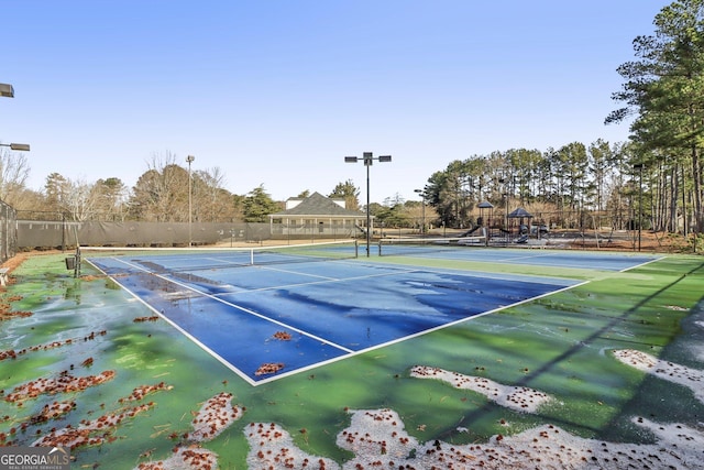 view of sport court with a playground