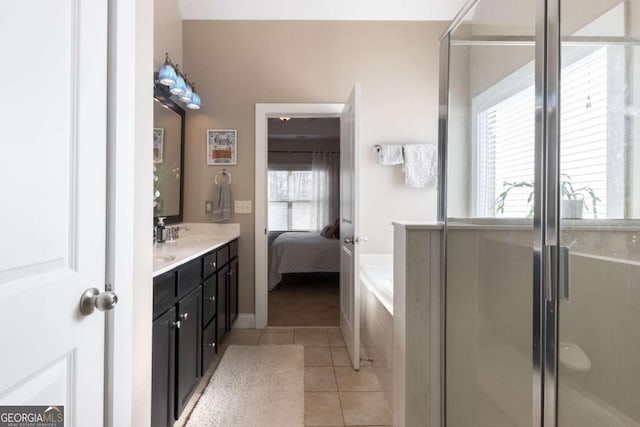 bathroom featuring vanity, independent shower and bath, and tile patterned flooring