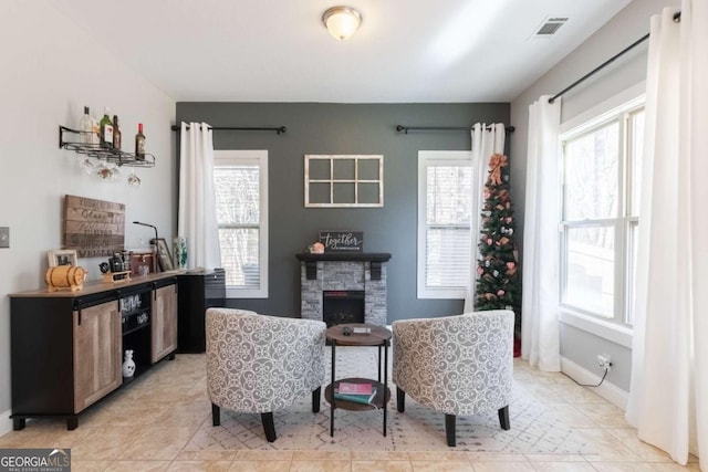 sitting room with a healthy amount of sunlight and a fireplace