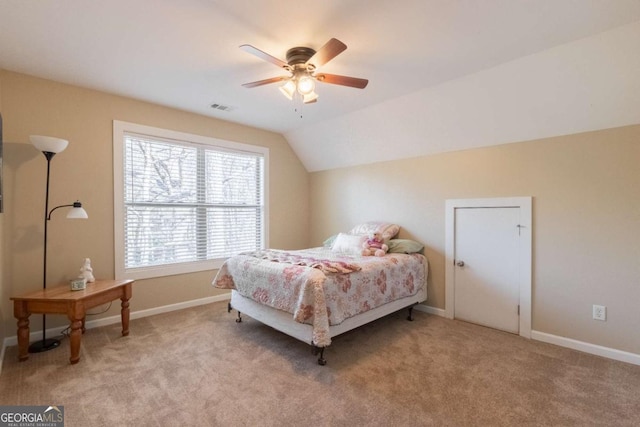 bedroom featuring ceiling fan, lofted ceiling, and light carpet