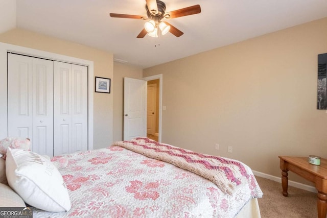 carpeted bedroom featuring ceiling fan and a closet