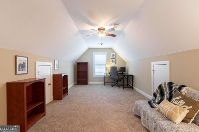 carpeted office space featuring lofted ceiling and ceiling fan