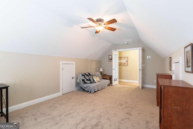 interior space with lofted ceiling, light carpet, and ceiling fan