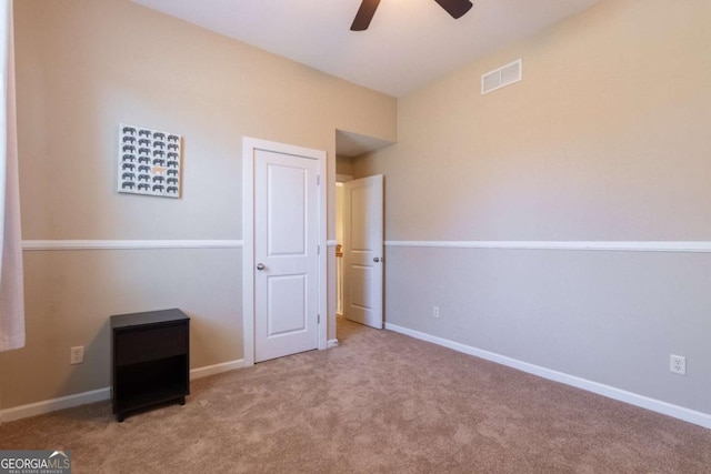 unfurnished bedroom featuring ceiling fan and light carpet