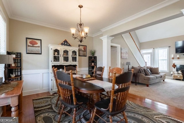 dining space featuring crown molding, hardwood / wood-style floors, and a notable chandelier